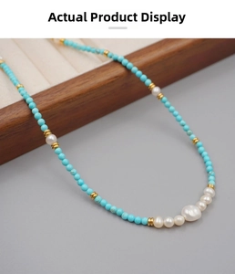Close-up of turquoise beads and baroque pearls on a vintage beaded necklace