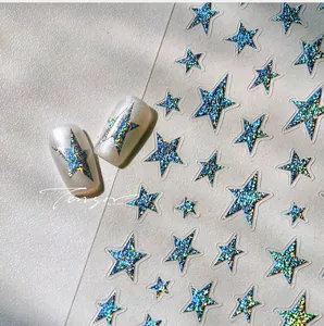 Close-up of holographic silver star nail stickers with 3D glitter effect on white tips