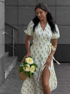 Detail of yellow tulip print on white cotton dress with puff sleeves and wrap tie