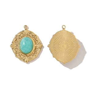 Detail showing vintage gold embossed pendant with green stone and radial pattern back