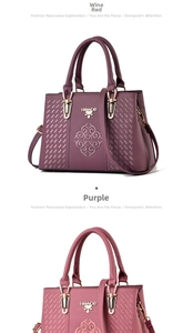 Detail view of wine red and purple faux leather handbags with classical floral embroidery