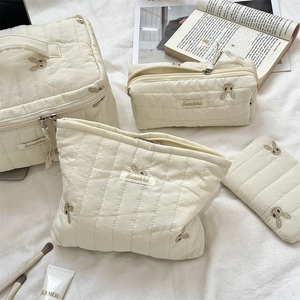 Quilted storage bag set with cute rabbit embroidery on soft cream fabric detail