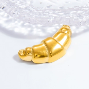 Macro shot of luxury golden croissant base and transparent hammered glass bowl detail