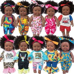 Ten 12-inch African American baby dolls in colorful outfits and headbands on white background