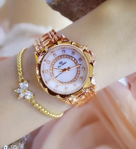 Close-up of rose gold watch and flower bracelet set with crystal mother of pearl dial