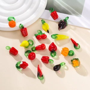 Detailed close-up of fruit and vegetable glass charms for DIY handmade jewelry
