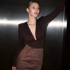 Detail of slim-fit brown V-neck top with ruching and long sleeves for a sleek look
