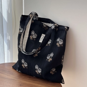 Floral black jacquard shoulder bag with rose pattern and textured fabric in Chinese style