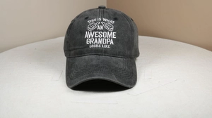 Detail of embroidered 'Awesome Grandpa' text on washed cotton vintage baseball cap
