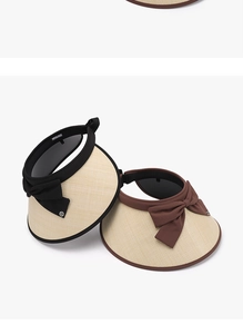 Close-up of black and coffee straw sun hats with elegant bow knots and metal HI detail