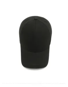Top-down view of black winter wool baseball cap with metallic logo and textured fabric