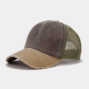 Detailed macro view of vintage distressed baseball cap with three-color mesh panel stitching