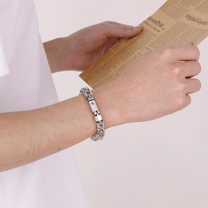 Men's stainless steel paperclip chain bracelet with polished spring clasp on wrist