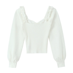 Detail of white square-neck knit top with ruffle trim straps and ribbed texture fabric