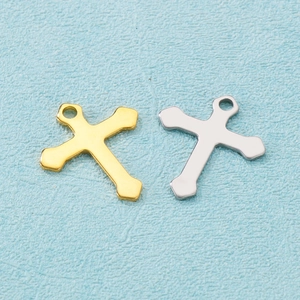 Polished stainless steel cross pendants in gold and silver finishes on light blue texture
