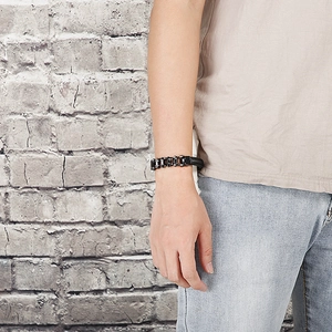 Macro shot of gunmetal mechanical chain bracelet with industrial gear link design