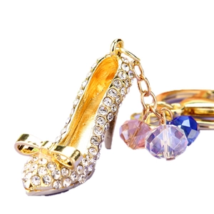 Sparkling high heel keychain with rhinestones, crystal beads and a golden bow accent