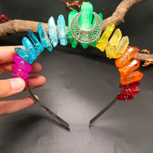 Detailed shot of raw rainbow crystals and silver moon accent on a mystic crown headband