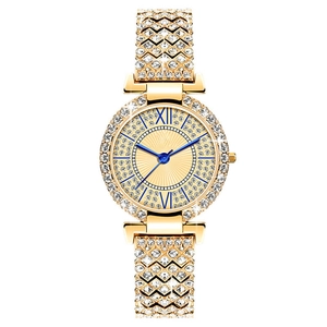 Detailed view of luxury gold women's watch featuring rhinestone bezel and blue Roman numerals