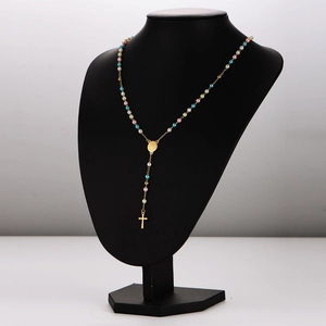 French style colorful pearl rosary necklace with gold cross pendant on a black bust