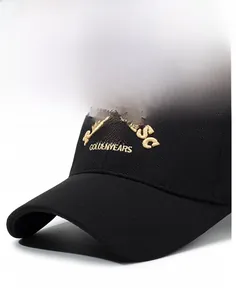 Close-up of golden embroidery reading REMINISC 1987 on high-density black cotton baseball cap