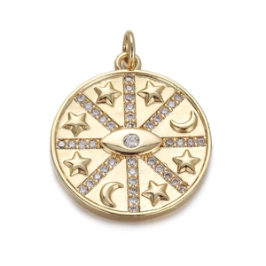 Detail of gold evil eye charm with embossed moon and stars and clear crystal inlays