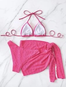 Detailed texture of rose pink three-piece bikini set with matching beach skirt wrap