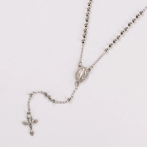 Detailed view of silver stainless steel rosary beads necklace with cross and oval medal