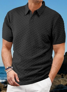 Close-up of black men's Polo shirt featuring textured jacquard fabric and V-pattern detail