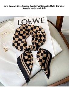 Detail of checkered pattern silk scarf tied on a shirt collar with soft texture