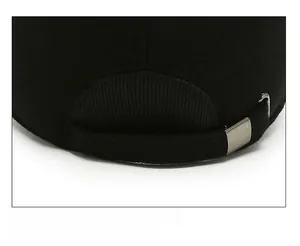 Detail of adjustable metal buckle and black twill cotton strap on winter thermal cap