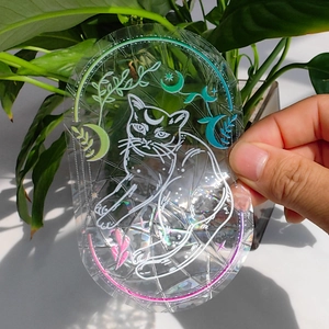 Holographic suncatcher sticker with cat and moon patterns reflecting rainbow prism light