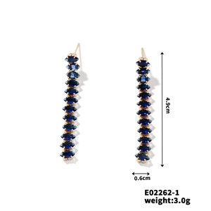Detail view of retro copper earrings with blue zircon and size dimensions 4.9cm x 0.6cm