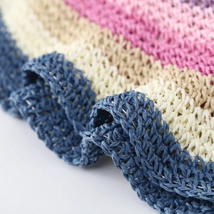 Macro shot of colorful woven texture on summer straw hat showing vibrant craftsmanship