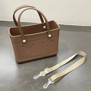 Detail view of medium brown waterproof EVA beach bag with a detachable shoulder strap.