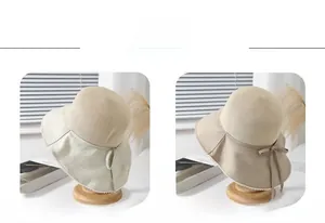 Detail of straw woven bucket hat with lace trim and elegant bow ribbon in beige and khaki