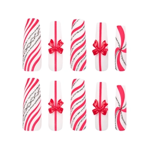 Extra long red and white coffin nails with 3D bows and candy cane glitter stripes