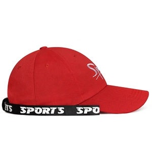 Red cotton baseball cap with letter embroidery and sports ribbon strap on plain background