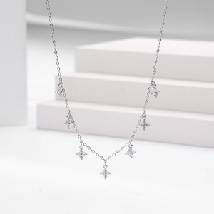 Macro shot of S925 silver necklace with seven zircon-encrusted flower pendants on an O-chain