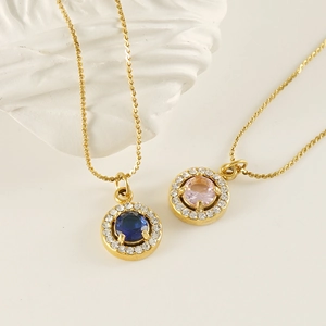Detail of 18K gold necklaces featuring blue and pink zircon pendants on a white background