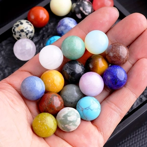 Close-up of various 16mm natural crystal balls held in hand for feng shui decor
