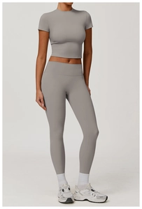 Detail of high-waist yoga set with grey slim fit short sleeve top and leggings for fitness