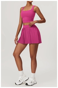 Detailed view of pink square-neck sports top and pleated high-waisted tennis skirt set