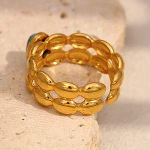 Macro shot of 18K gold plated double-layered ring featuring a blue turquoise stone