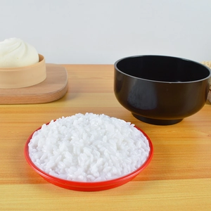 Detailed close-up of fake rice bowl with dim sum steamer and soup model on a tray