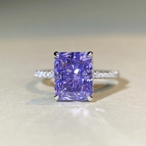 Macro shot of 925 silver ring featuring a radiant cut purple gemstone and diamond band
