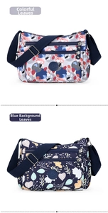 Detail view of lightweight nylon crossbody bags in colorful and navy blue leaf prints