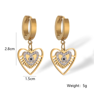 Macro shot of gold heart-shaped evil eye earrings with size dimensions 2.8cm and 5g weight