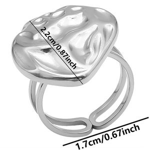 Detail view of irregular hammered silver texture ring with adjustable opening dimensions