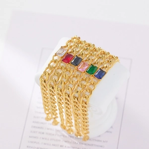 Detail of gold Cuban bracelets with colorful square zircons on a white display